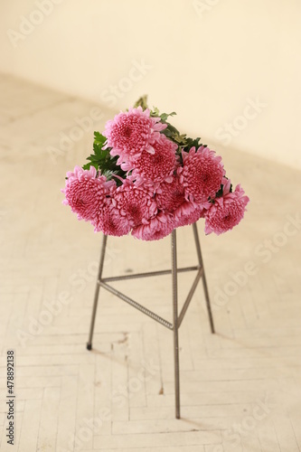 a bouquet of pink flowers lies on a chair