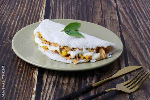 Chicken tapioca with corn and cream cheese. Basil leaf on top. photo
