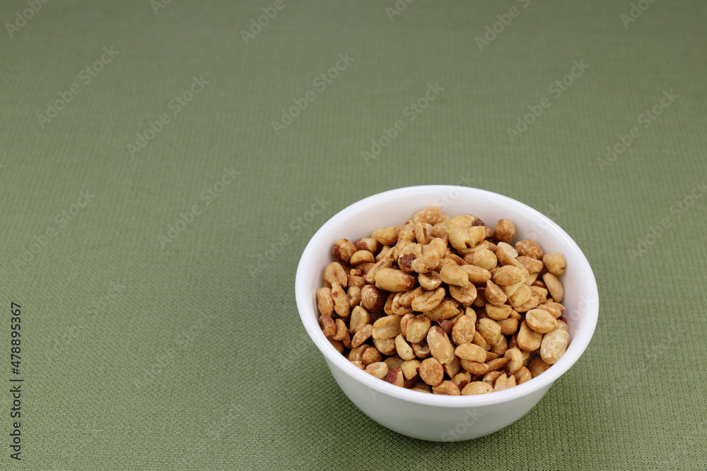 Round White Bowl Filled with Dry Roasted Salted Peanuts Snack. Round White Bowl Filled with Dry Roasted Salted Peanuts Snack.