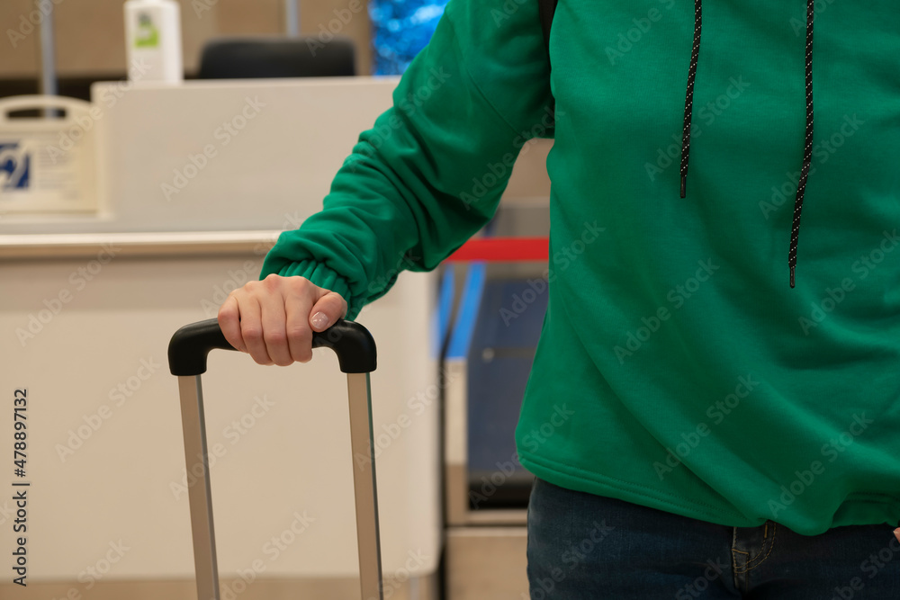 Girl in a protective mask with luggage in the check in area. Girl in a protective mask with luggage in the check in area.