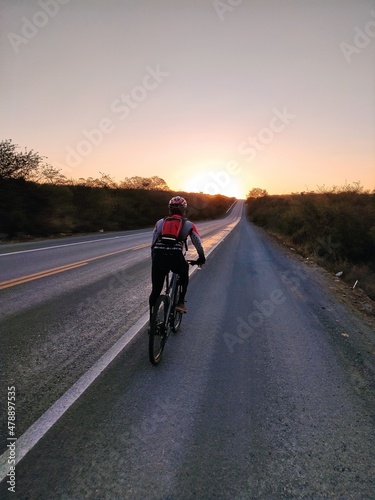 biker on the road in sunset