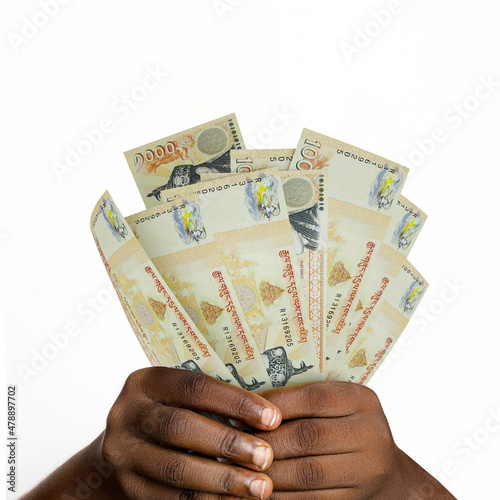 hands holding 3D rendered Bhutanese ngultru notes. closeup of Hands holding Bhutanese currency notes