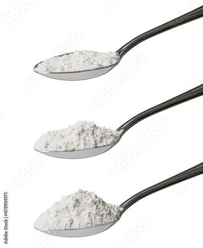 Set of three tablespoons of refined white flour showing an angled view of level, rounded and heaped measurements isolated on a white background