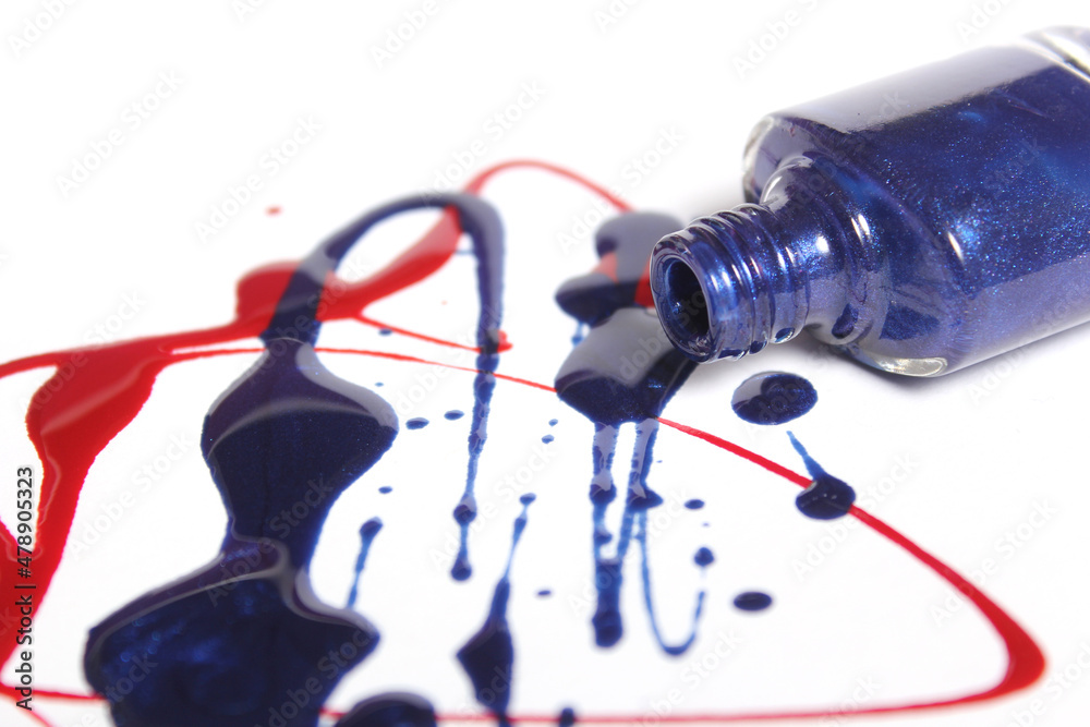 Naklejka premium Red and Blue Spilled Nail Polish on White Background