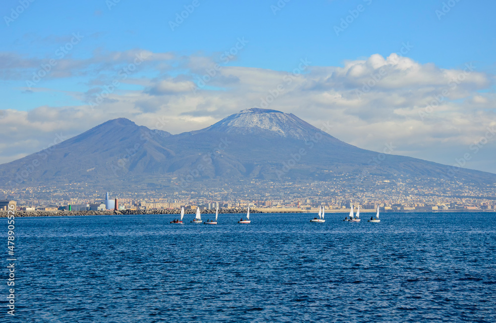 Gulf of Naples, mount Vesuvius and small sailboats in the blue sea