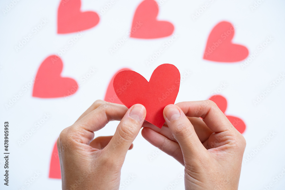 two hands holding one heart two hands holding one heart