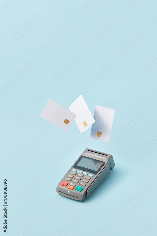 Three bank cards falling on payment terminal Three bank cards falling on payment terminal