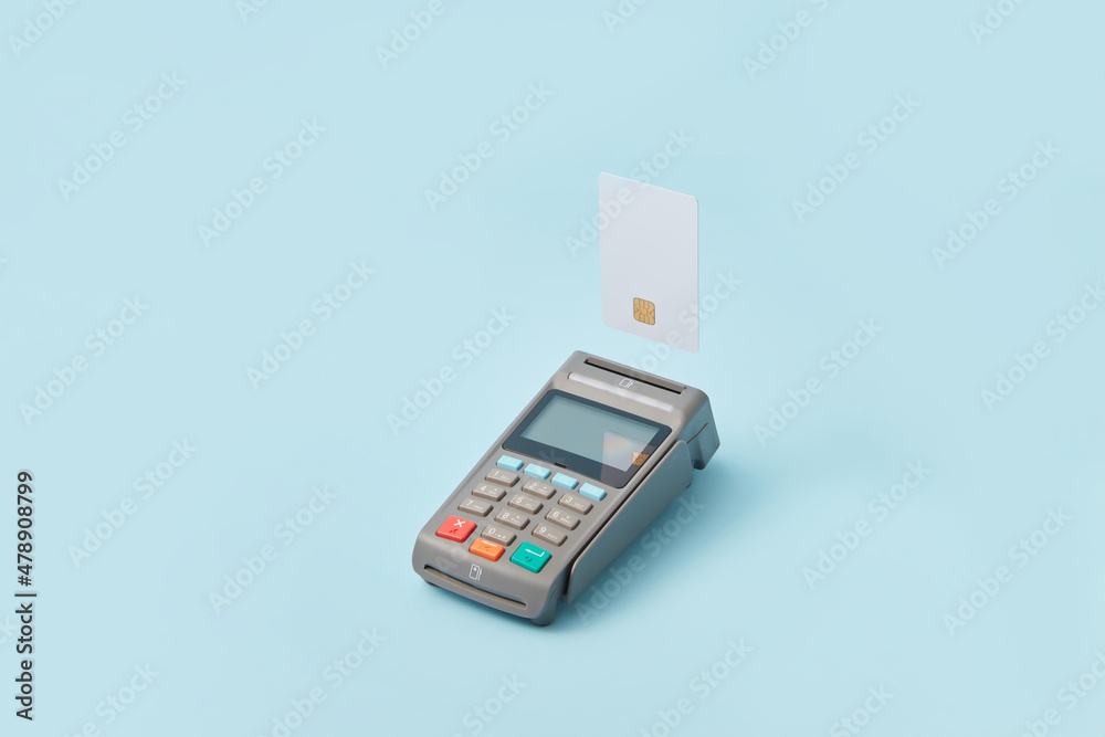 Terminal and credit card on light blue background Terminal and credit card on light blue background