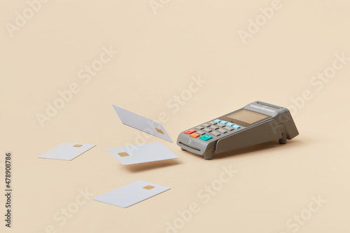 Pos terminal with falling credit cards photo