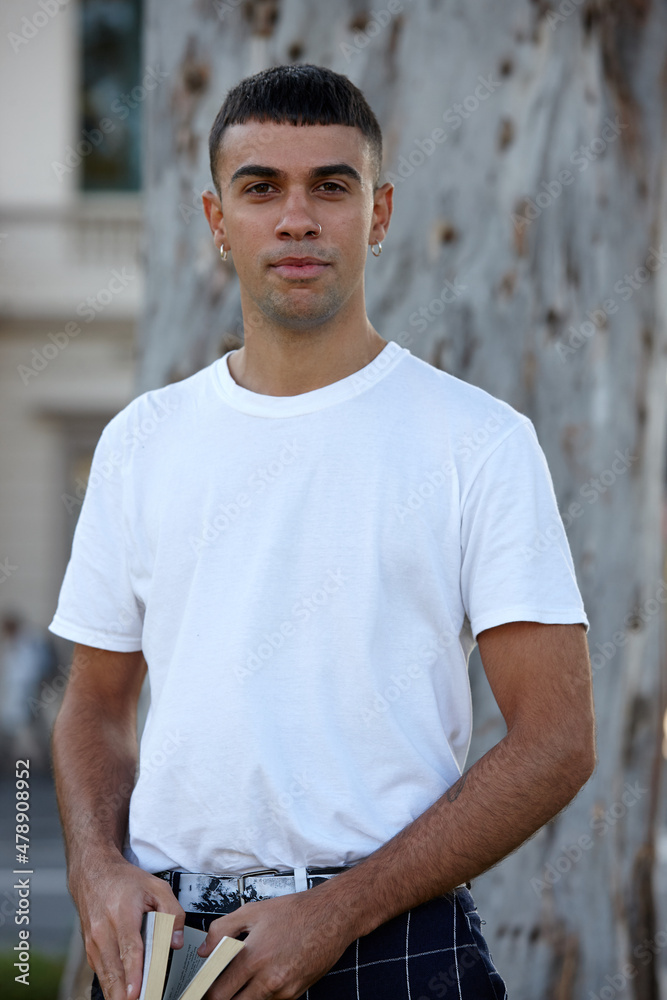 Young Indigenous Australian man with book outdoors Young Indigenous Australian man with book outdoors