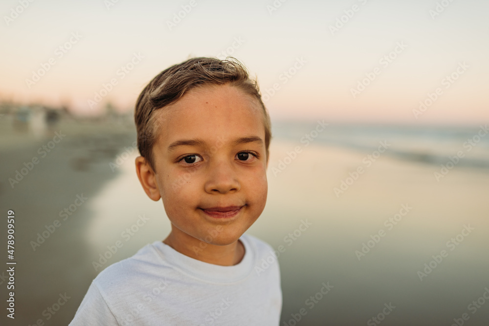 Young boy at the beach at sunset Young boy at the beach at sunset