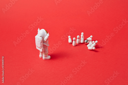 Cosmonaut making strike in bowling