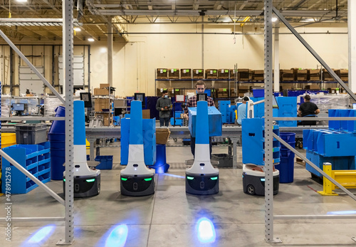 Employee Entering order information on multiple robots  