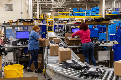 Two workers together at busywarehouse for E-Commerce  photo