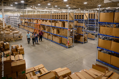 Employees Meeting in aisle at warehouse  photo