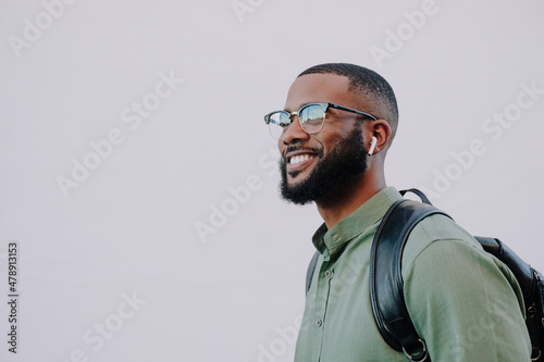 Bearded man with glasses and ear buds.  photo