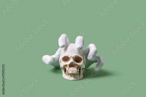 Scary cut hand catching skull photo