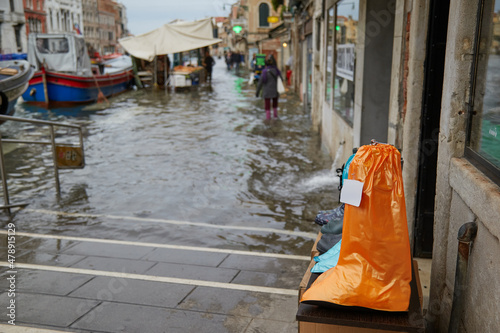 Venice gumboot shoe cover for sale in flooded shop