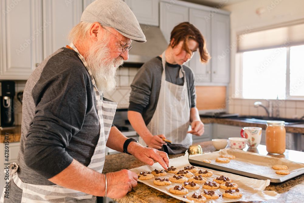 Grandpa making baked cookies with his grandboy Grandpa making baked cookies with his grandboy