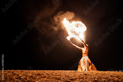 showman breathes fire from his mouth photo