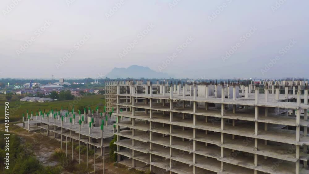 Aerial top view of abandoned apartment or hotel under construction site with structure. Top view of precast concrete slap floor. Development architecture buildings. Aerial top view of abandoned apartment or hotel under construction site with structure. Top view of precast concrete slap floor. Development architecture buildings.