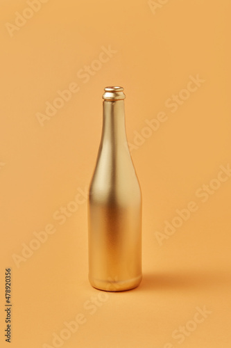 Bottle of champagne painted in golden color photo