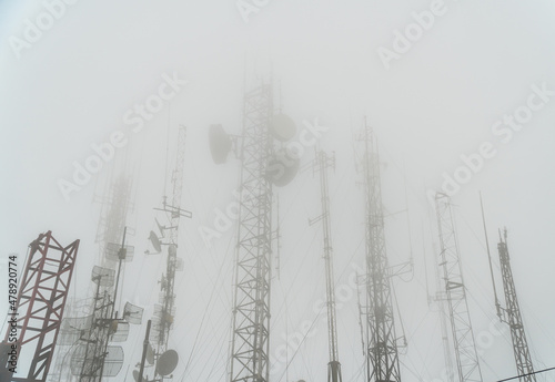 antenna towers covered with fog in mountain. Telomoyo, Central Java, Indonesia. electric and industrial. photo