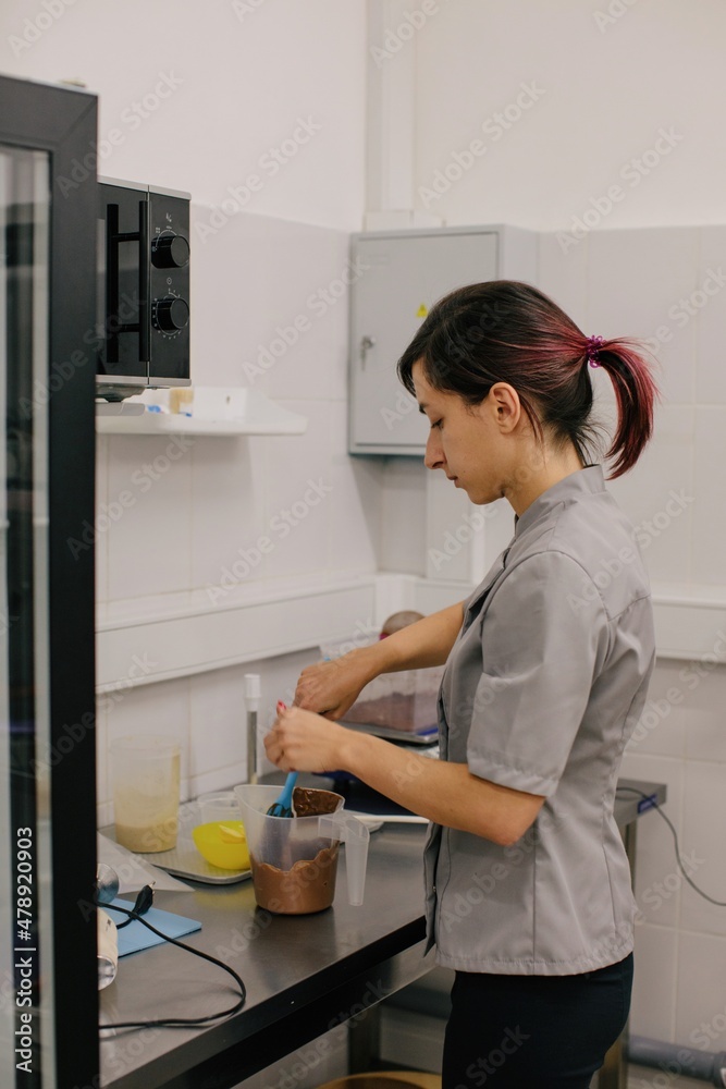 Woman baker making cream for dessert Woman baker making cream for dessert