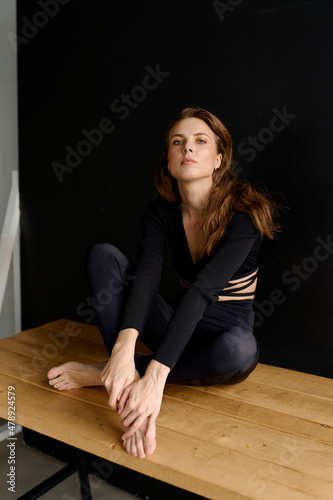 portrait of a woman in black clothes on a black background photo