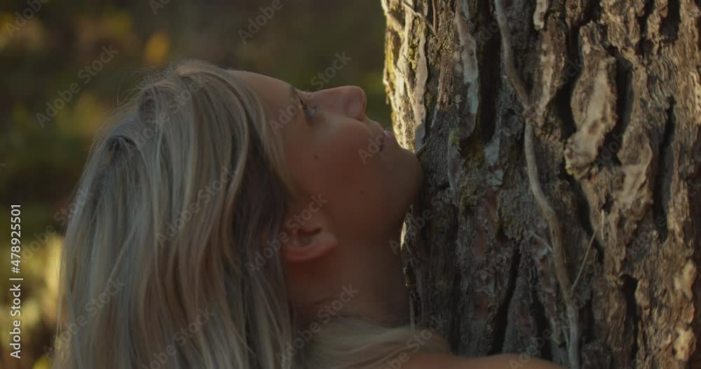 Caucasian Woman Hugging A Tree In The Forest. - close up Caucasian Woman Hugging A Tree In The Forest. - close up