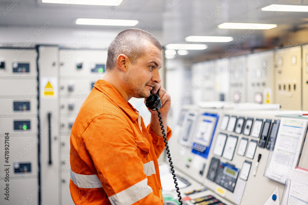 © Igor Kardasov/Stocksy - Vessel mechanic talking on the phone © Igor Kardasov/Stocksy - Vessel mechanic talking on the phone