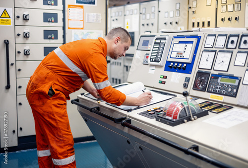 Engineer filling engine logbook photo