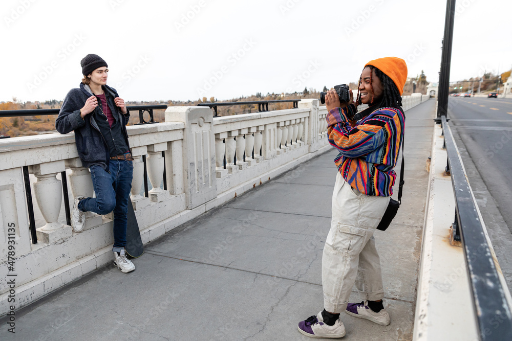 Taking Photo Of Boyfriend On A Bridge Taking Photo Of Boyfriend On A Bridge