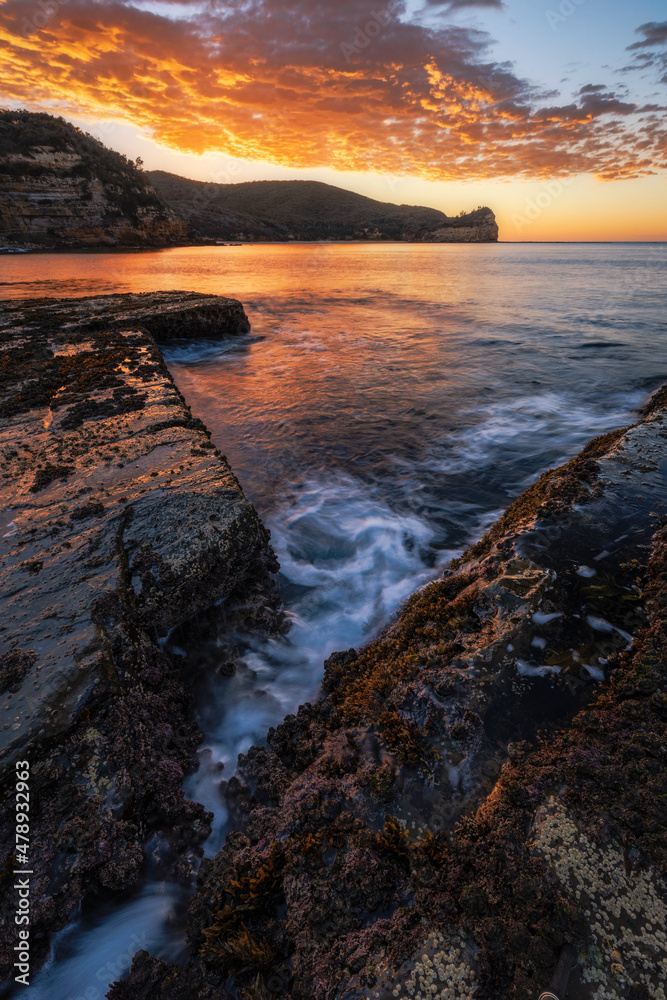 sunrise over rocks and water in bouddi national park on nsw central coast