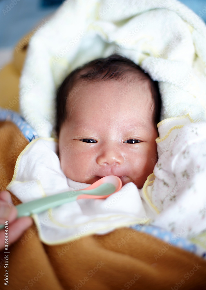 Closeup of Asian newborn baby being fed Closeup of Asian newborn baby being fed