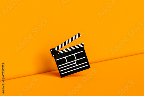 3d render of an empty clapperboard on orange 