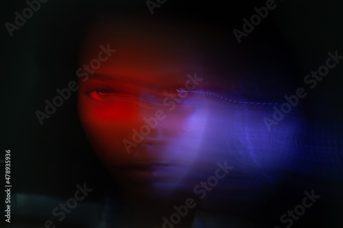 female face in neon light with blur