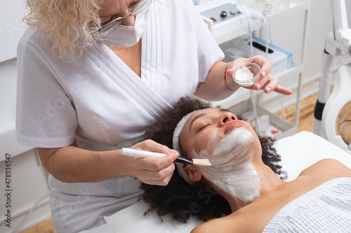 Beautician Applying A Face Mask On A Client