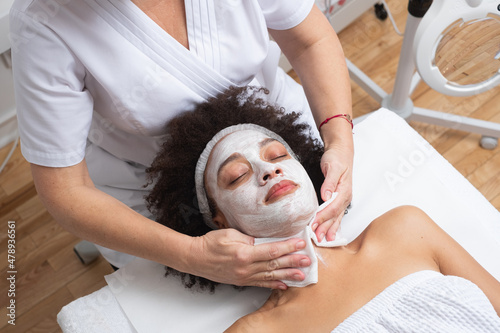 Beautician Doing A Face Mask Treatment With A Client photo