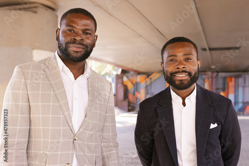 Confident businessmen in suit standing in the street photo