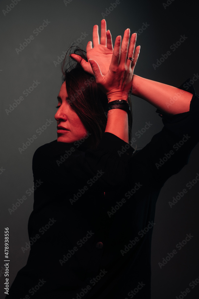 attractive dancing woman lit by red light attractive dancing woman lit by red light