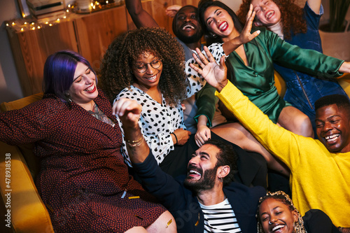 Group of friends laughing during party photo