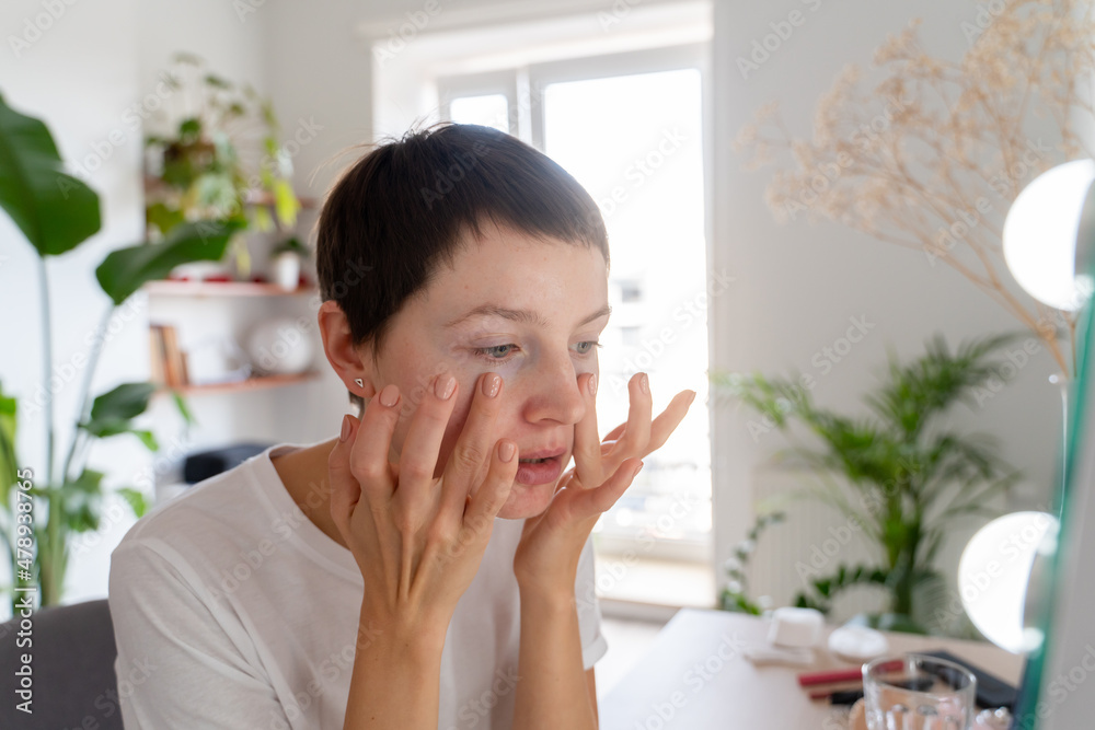 Woman Applying Skincare Product Indoors Woman Applying Skincare Product Indoors