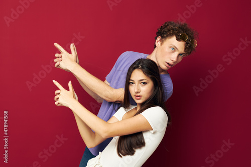 guy and girl posing studio red background