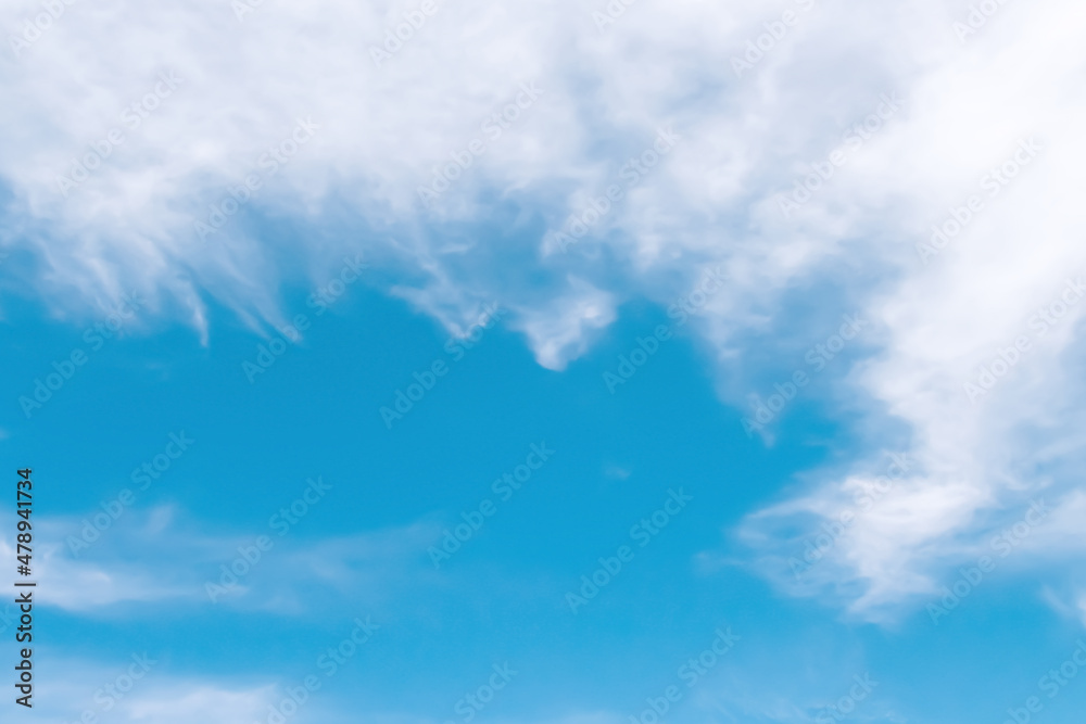 Soft clouds patterns on blue sky background with space