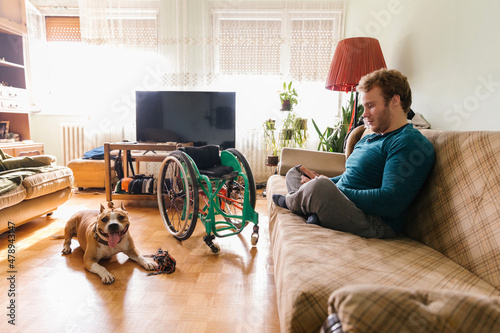 Man Relaxing At Home With His Dog photo
