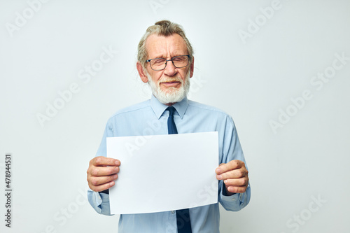 Portrait of happy senior man work office blank sheet of paper light background