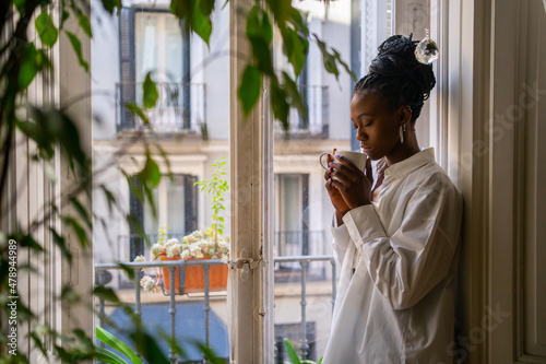 Cute Black Girl Warming Up Having A Hot Drink At Home photo