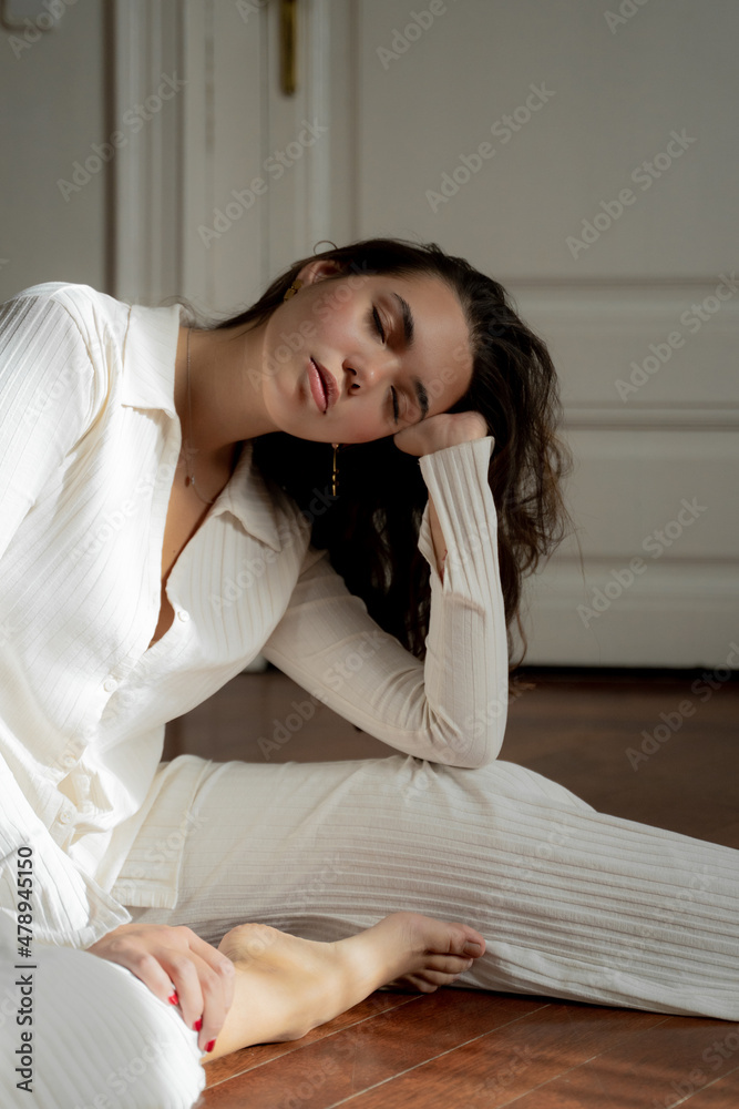 Young Woman With Closed Eyes Sitting On Floor Young Woman With Closed Eyes Sitting On Floor
