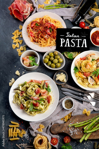 Pasta assortment on dark background. photo